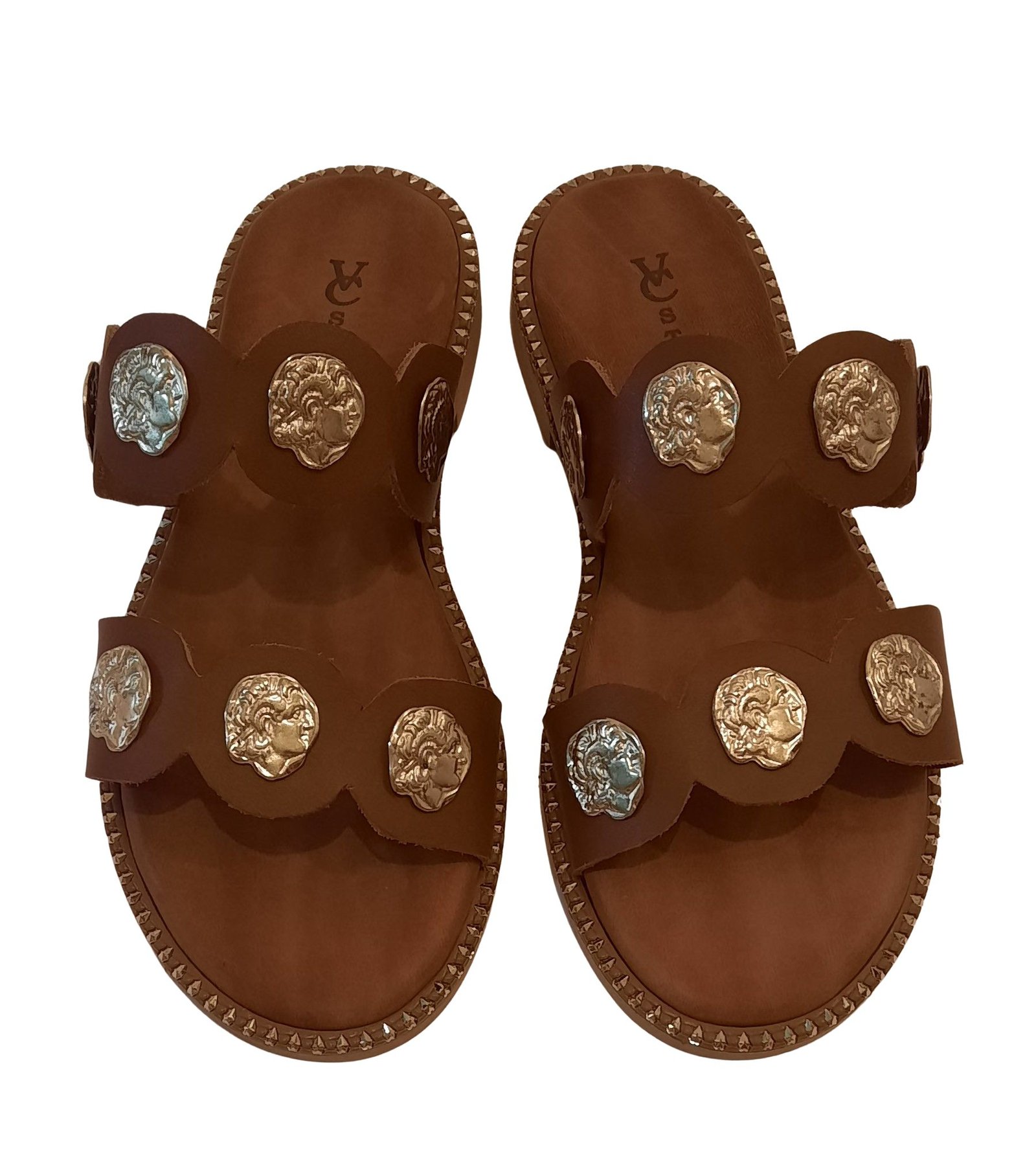 Handmade brown leather sandals with decorative metal elements from the company VCSTAFA