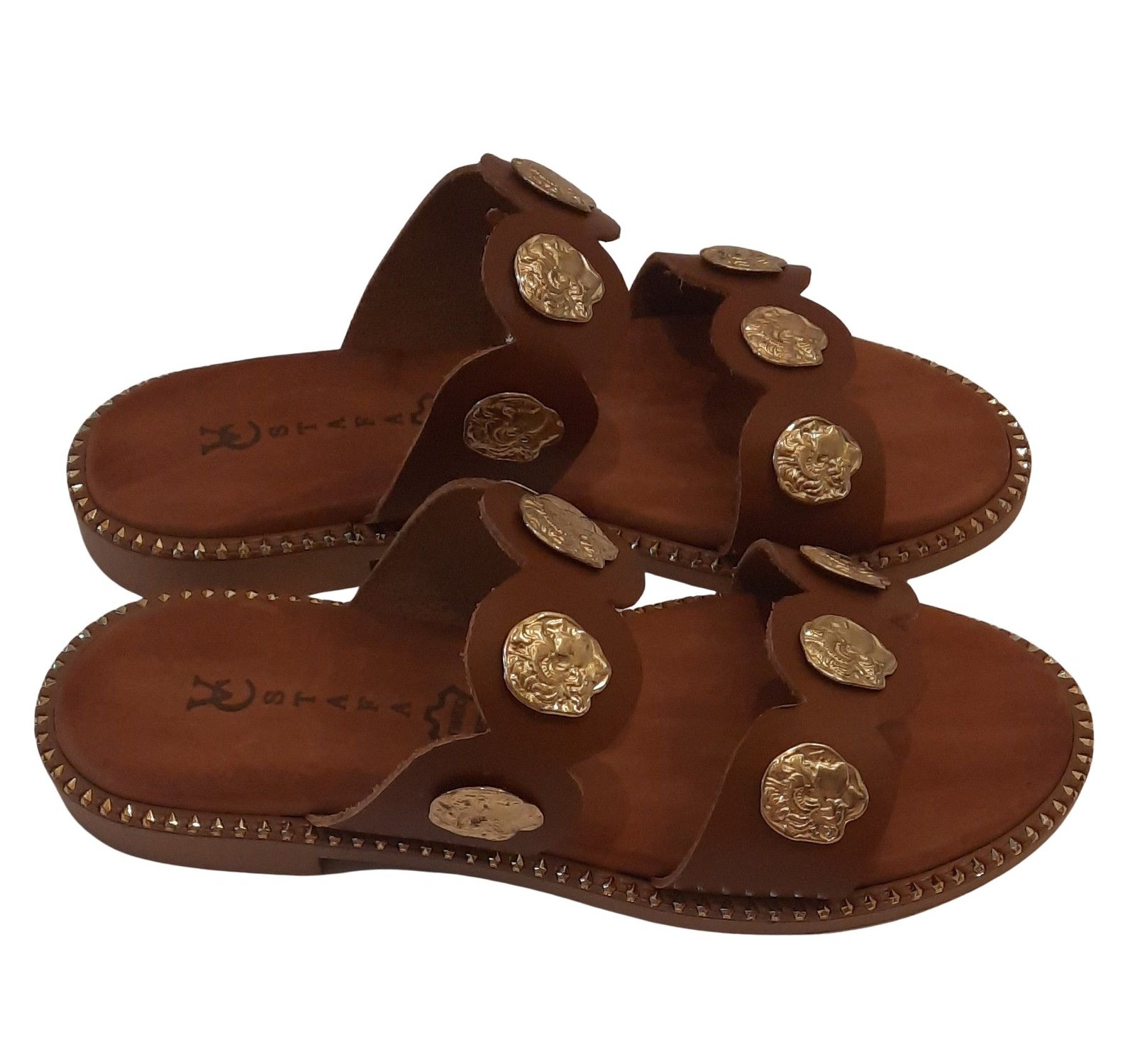 Handmade brown leather sandals with decorative metal elements from the company VCSTAFA