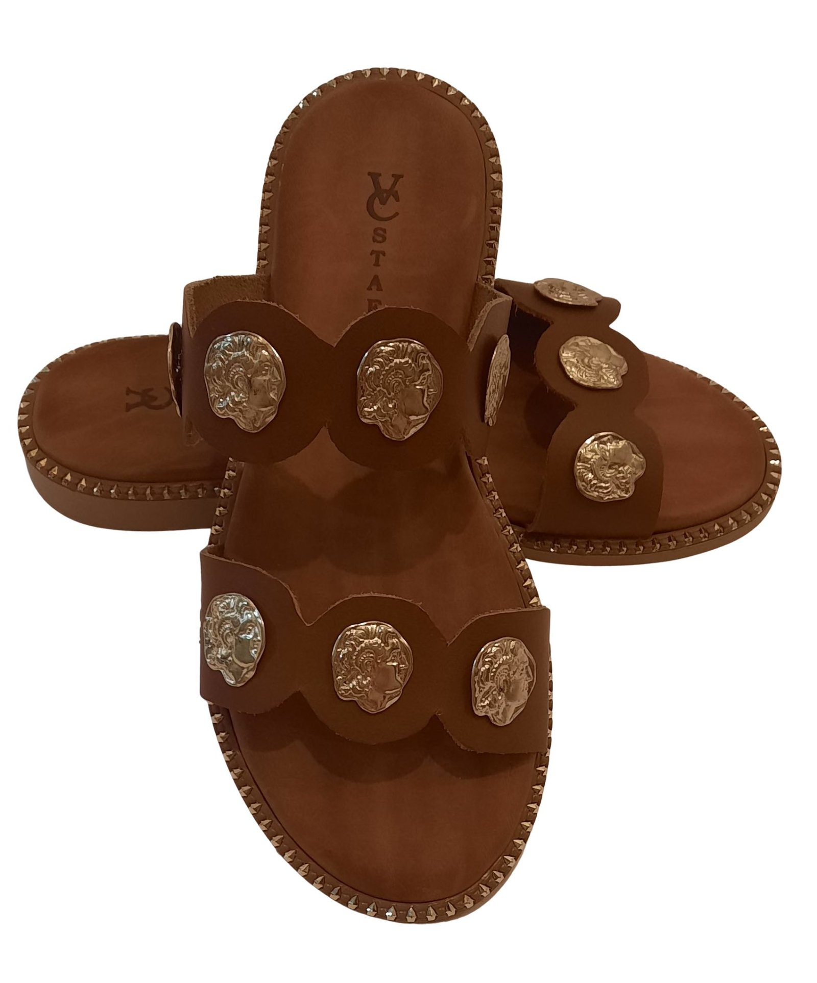 Handmade brown leather sandals with decorative metal elements from the company VCSTAFA